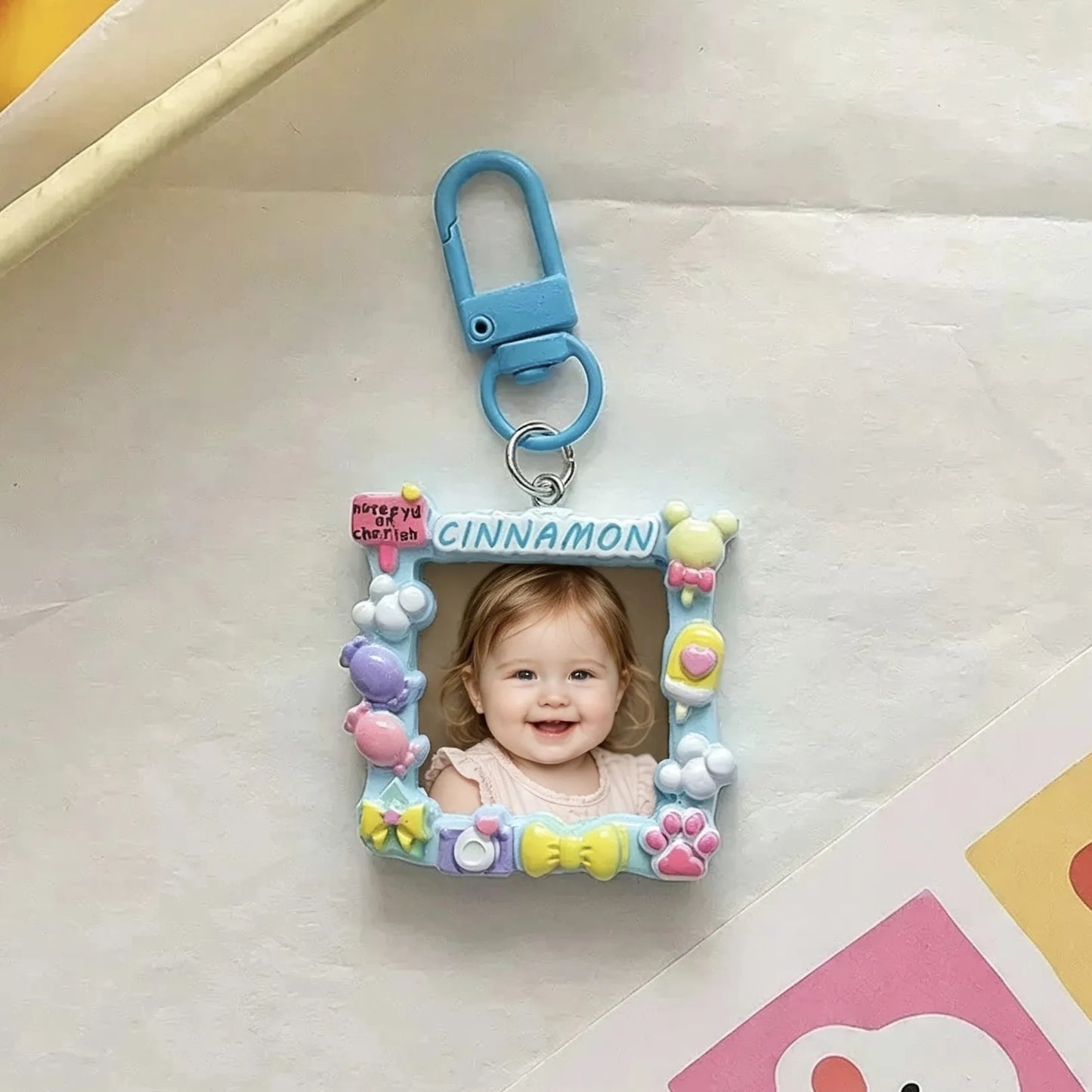 Custom picture keychain attached to house keys with personalized name and photo.