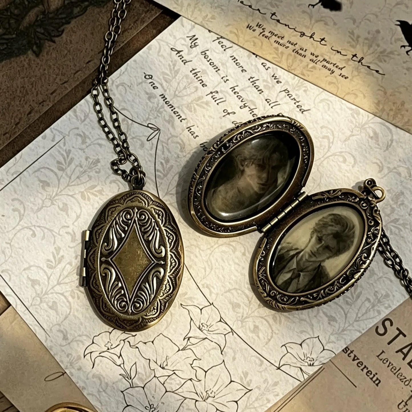 Flat lay of an open vintage photo locket necklace displaying two personalized keepsake photos.