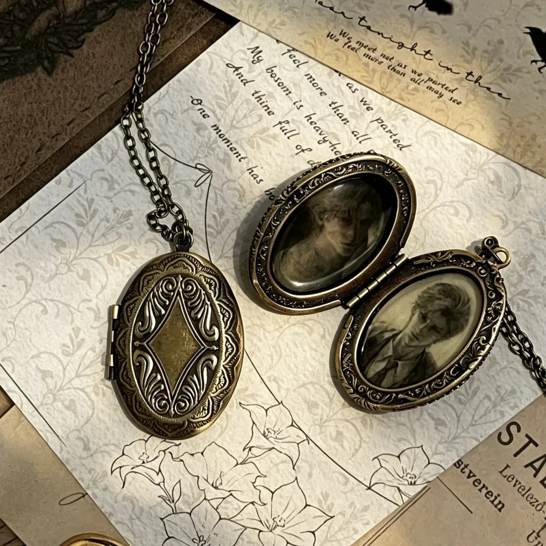 Flat lay of an open vintage photo locket necklace displaying two personalized keepsake photos.
