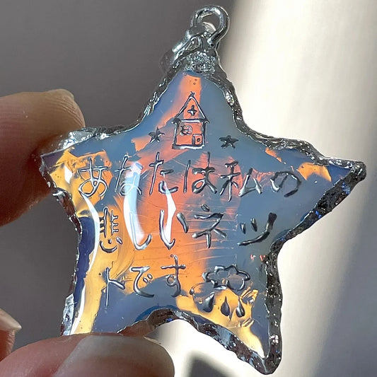 Personalized star charm featuring a colorful iridescent finish, handmade as a meaningful gift for loved ones and special memories.