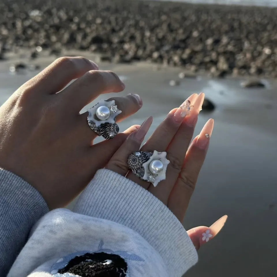 A handcrafted seashell memory ring featuring a vintage-inspired shell design and elegant pearl centerpiece. Perfect for ocean lovers and meaningful everyday wear.