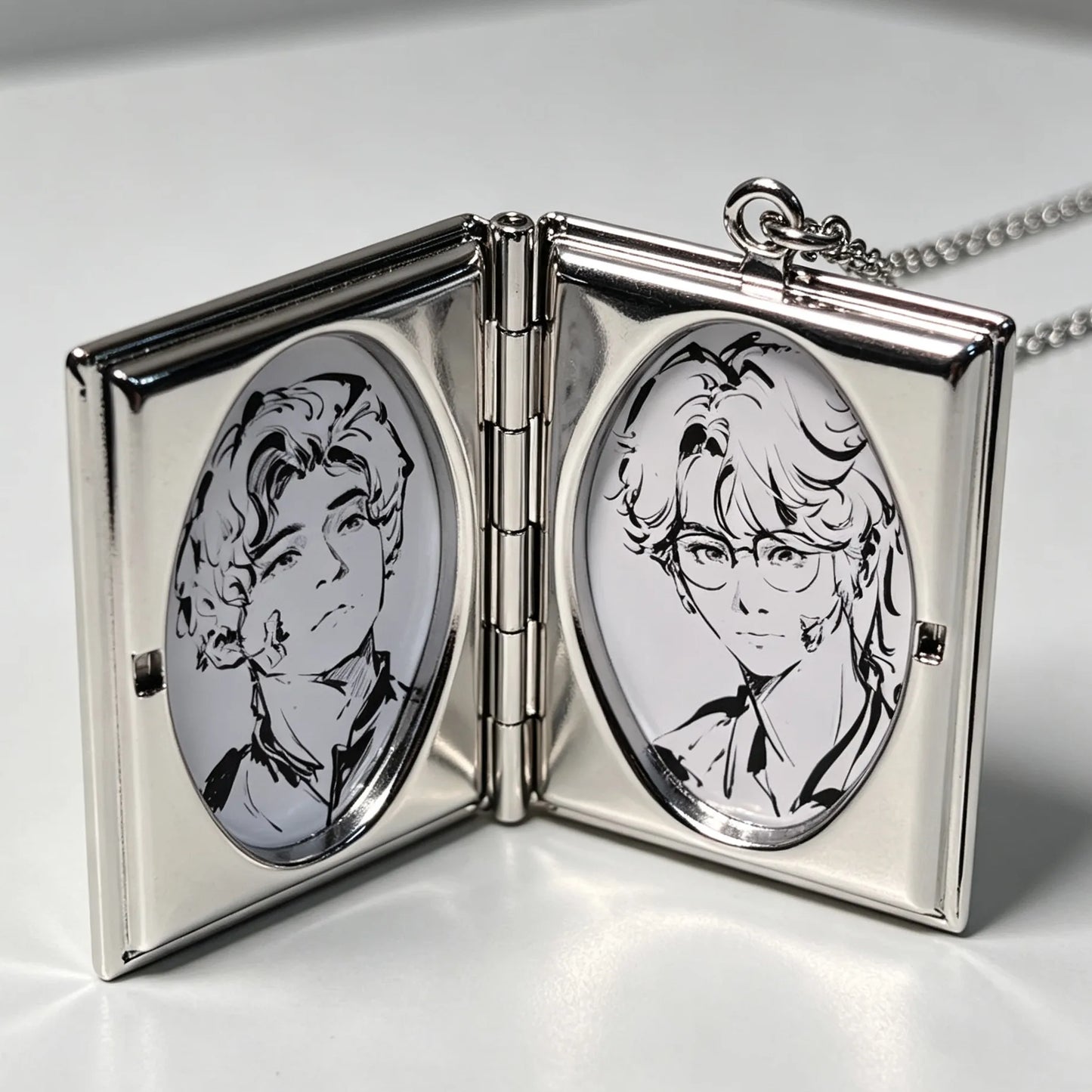 Open personalized photo locket necklace displaying two custom portrait photos inside the pendant.