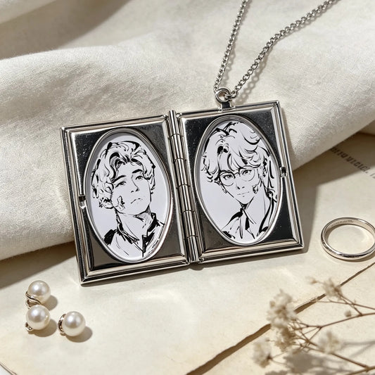 Personalized photo locket necklace opened to reveal two custom photos inside an elegant silver pendant.