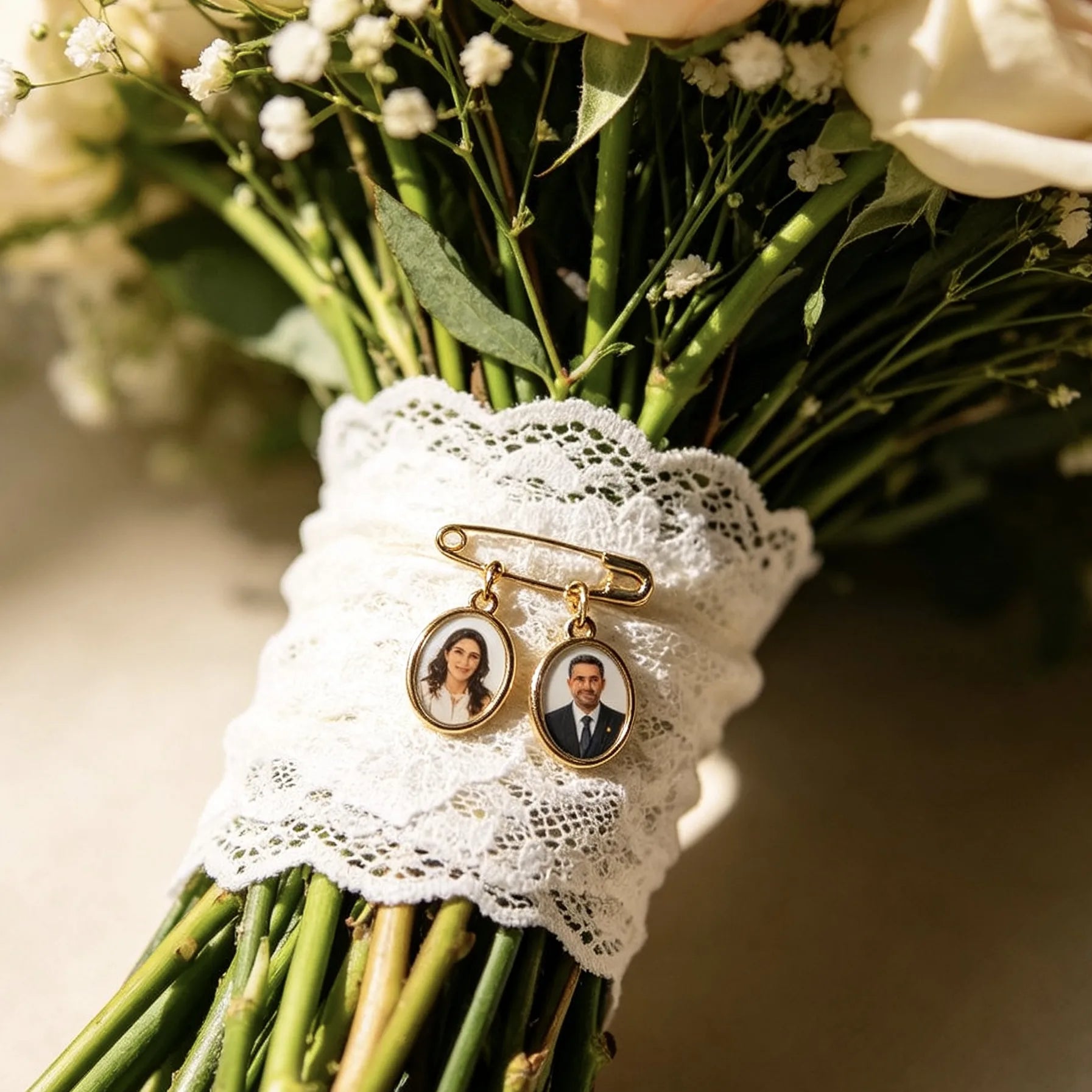 Personalized wedding bouquet memory brooch with custom photo charms attached to a bridal bouquet.